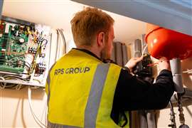 An installer works on retrofitting a heat pump to a residential property