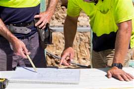 workers pointing to paper